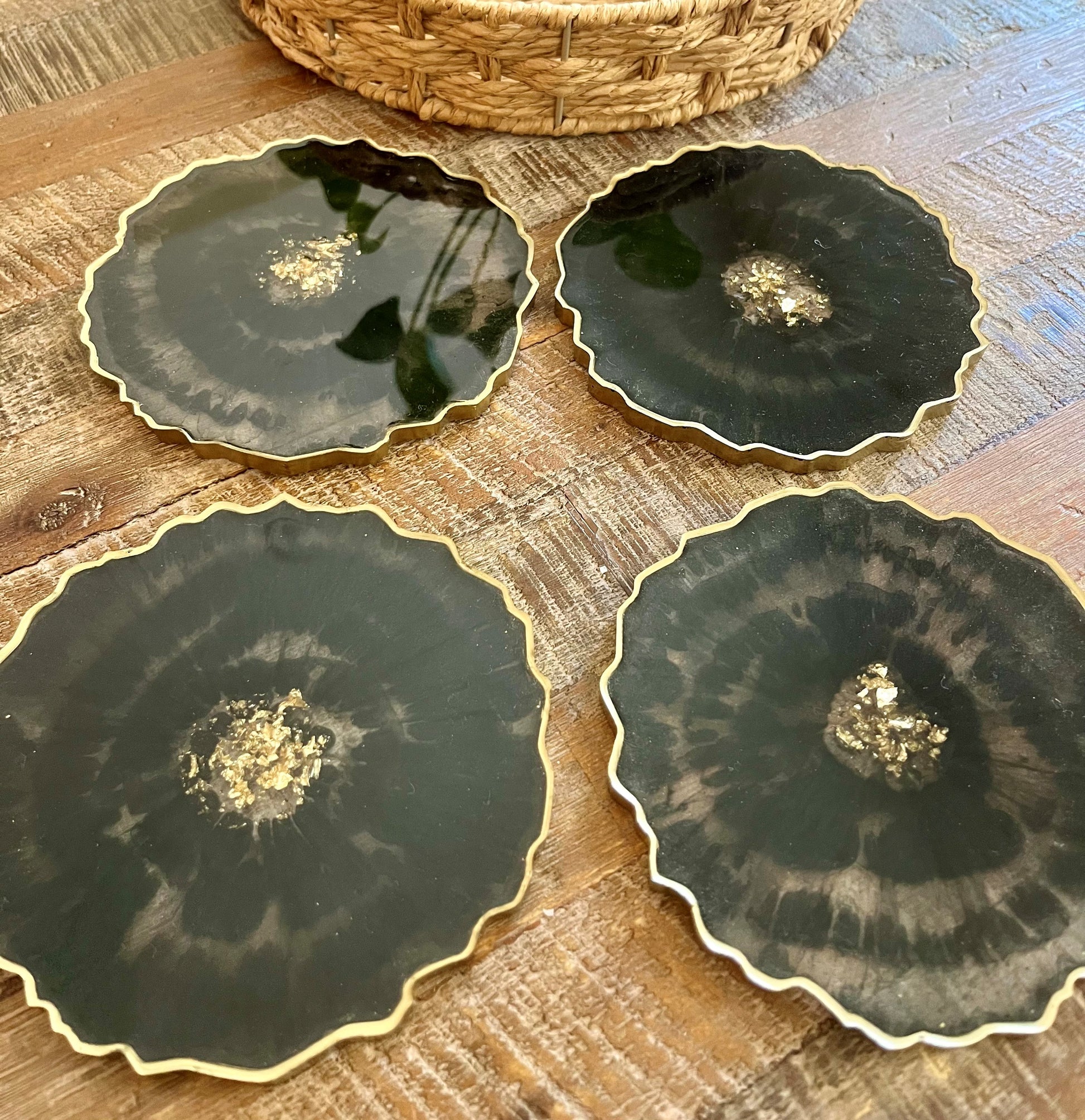 4 Geode Black Coasters with Gold flakes in the middle as well as a painted gold edge