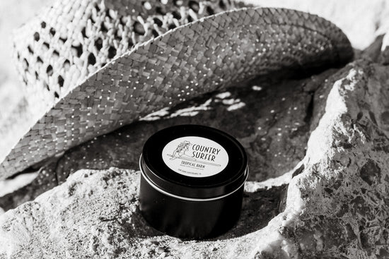 Tropical Barn Candle in front of Cowboy Hat