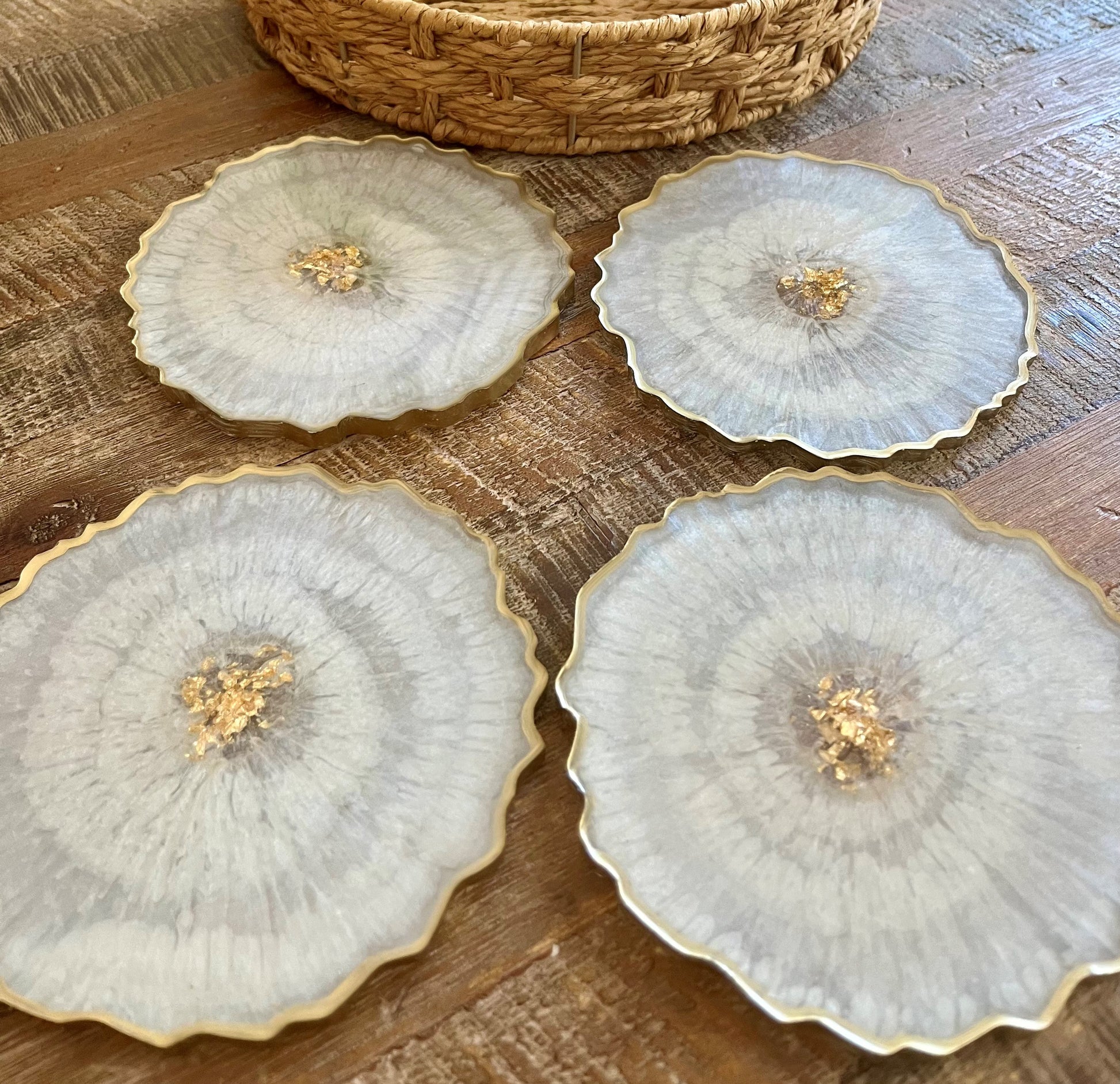 4 Geode White Coasters with Gold flakes in the middle as well as a painted gold edge